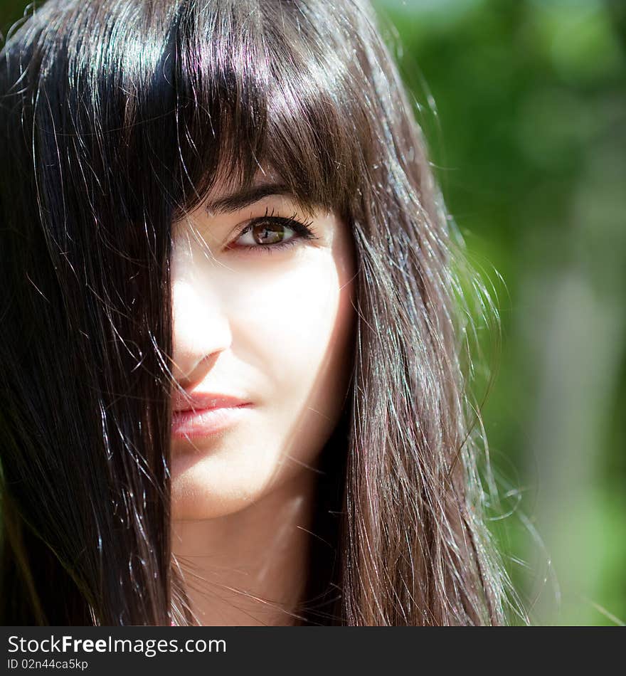 Young beautiful girl with long black hair, outdoors