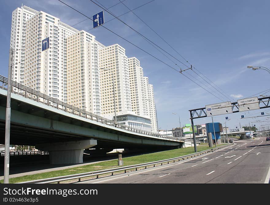 Urban scene with highway overpass and skyscraper building