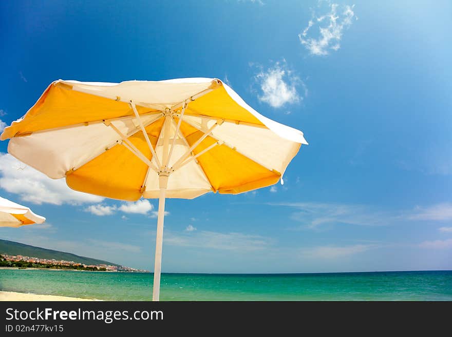 Vector orange umbrella on beautiful tropic beach