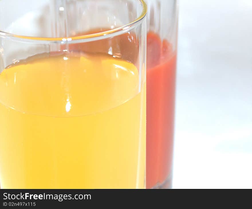 The tomato and orange juice in glass. The tomato and orange juice in glass.