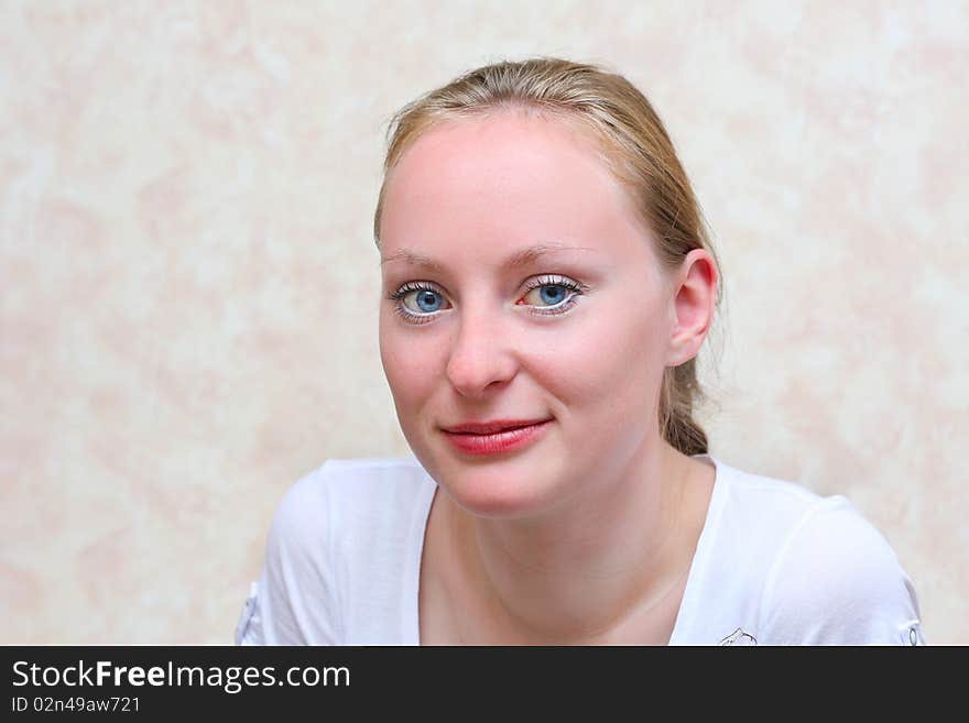 Girl in a white dress, on a white background, with an indifferent sight.