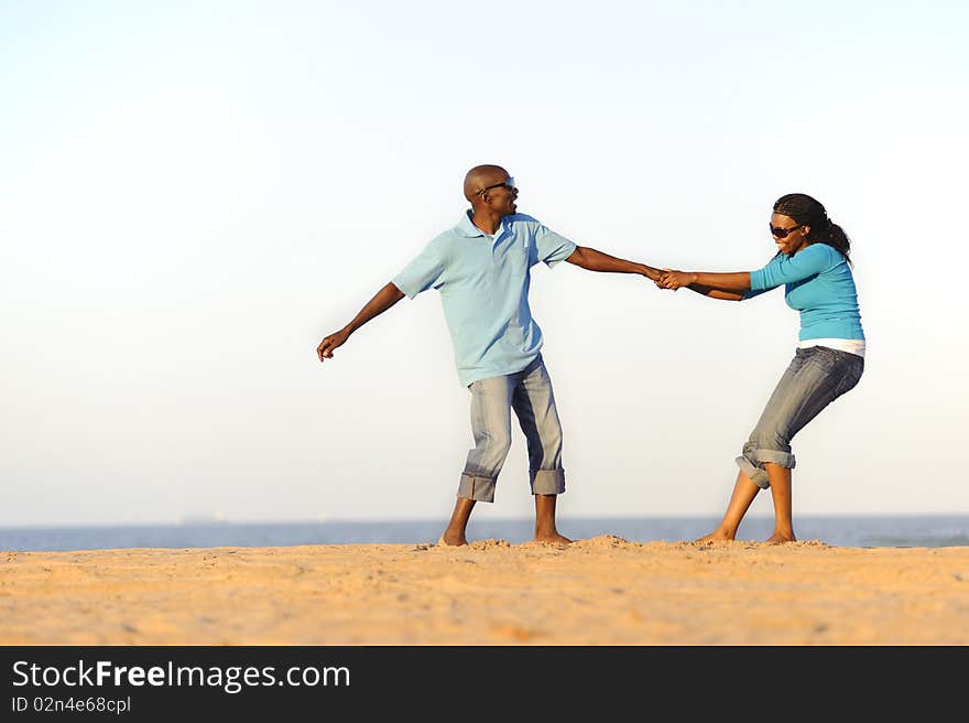 African American couple hand in hand on the beach. African American couple hand in hand on the beach