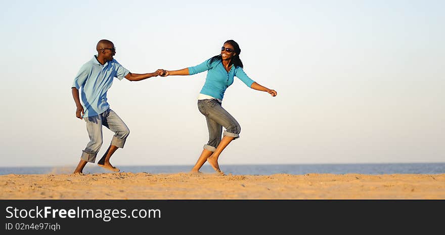 African American couple hand in hand on the beach. African American couple hand in hand on the beach