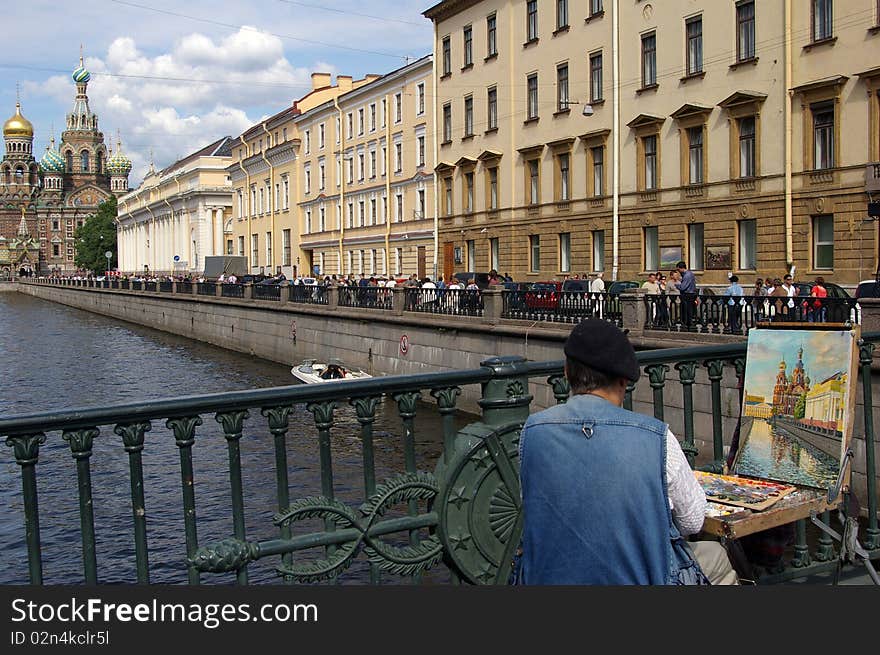 Street artist painting on a bridge of Saint-Petersburg the church of Resurrection of the Lord. Street artist painting on a bridge of Saint-Petersburg the church of Resurrection of the Lord.