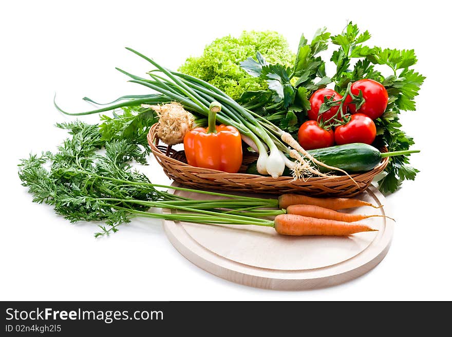 Organic vegetables in basket on white background