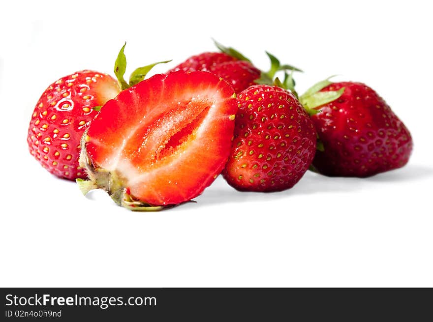 Some strawberries, with a half, with a shade on a white background. Some strawberries, with a half, with a shade on a white background