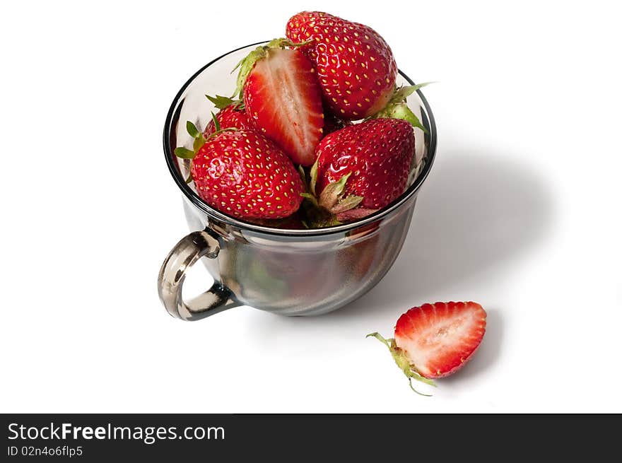 Ripe strawberry in a black cup with a shade on a white background. Ripe strawberry in a black cup with a shade on a white background