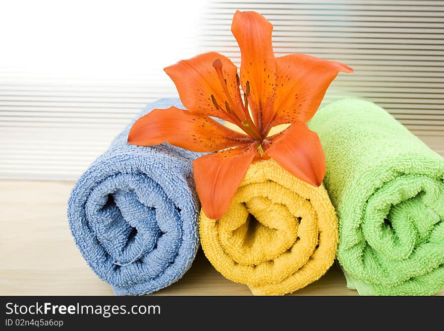 Colored towels are folded to lie next to them flower tiger lily. Colored towels are folded to lie next to them flower tiger lily