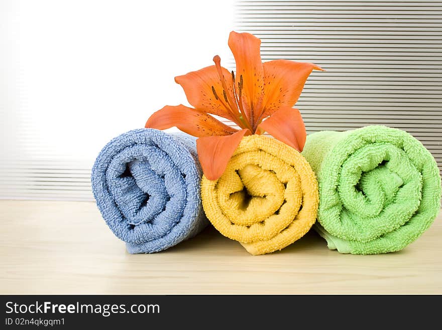 Colored towels are folded to lie next to them flower tiger lily. Colored towels are folded to lie next to them flower tiger lily