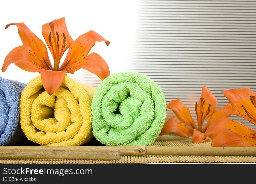 Colored towels are folded to lie next to them flower tiger lily. Colored towels are folded to lie next to them flower tiger lily