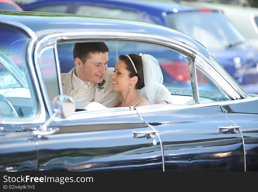 Newlywed couple, groom and bride, in car. Newlywed couple, groom and bride, in car