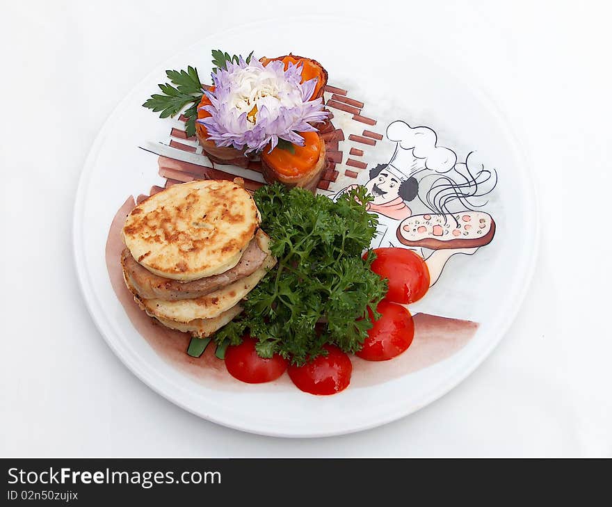 The ornament plate with medallions from pork with flat cakes from vegetable marrow under teriyaki sauce. The ornament plate with medallions from pork with flat cakes from vegetable marrow under teriyaki sauce.