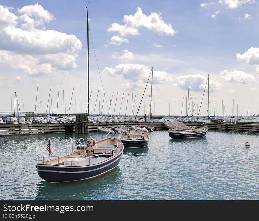 This is an image of tender boats owned by the city that help service the boats in the marinas along Lake Michigan. This is an image of tender boats owned by the city that help service the boats in the marinas along Lake Michigan.