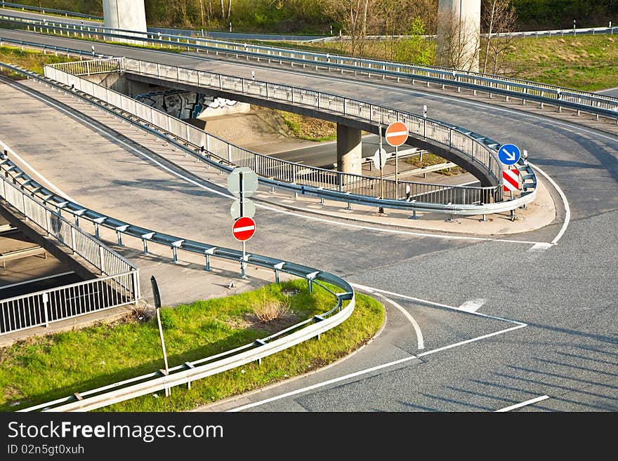 Empty highway with traffic signs in morning light