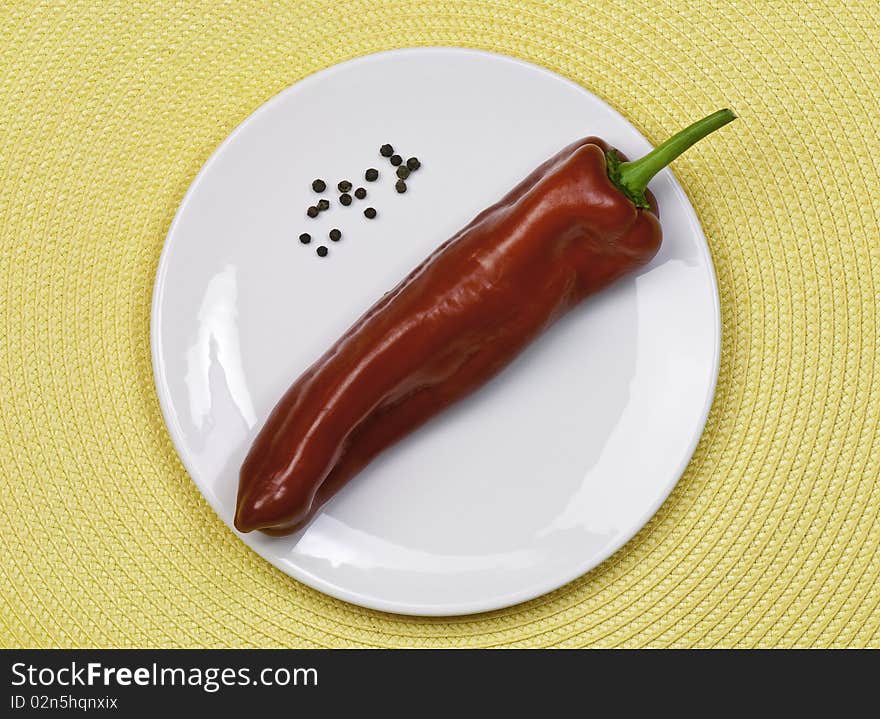 Fresh sweet red pepper on a white plate