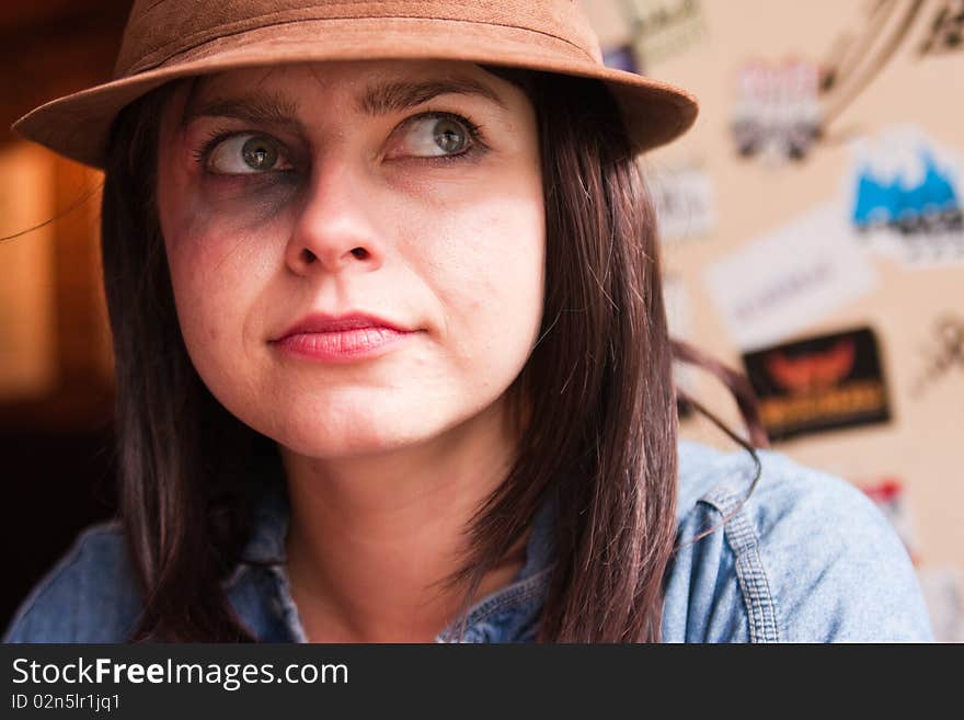 Girl with black-eye smiling slightly