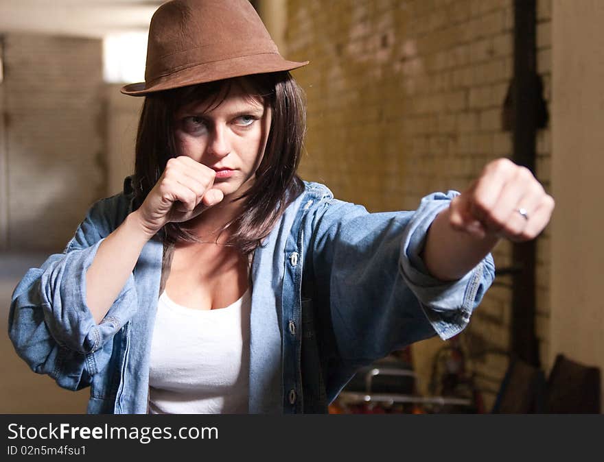 Attractive young woman throwing a punch. Attractive young woman throwing a punch