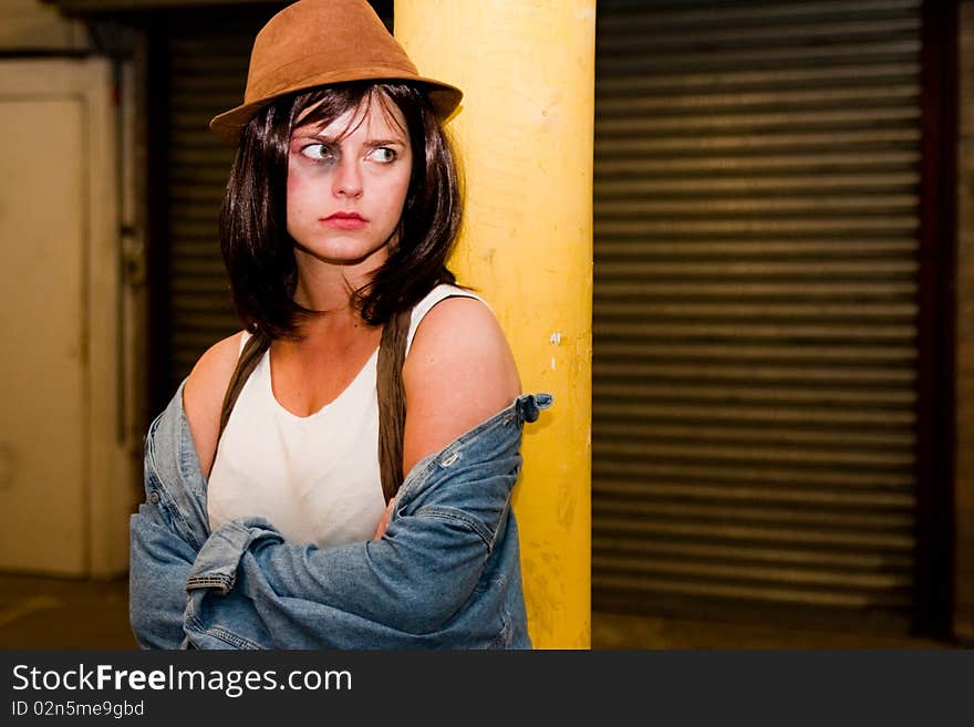 Angry young woman with black-eye in garage