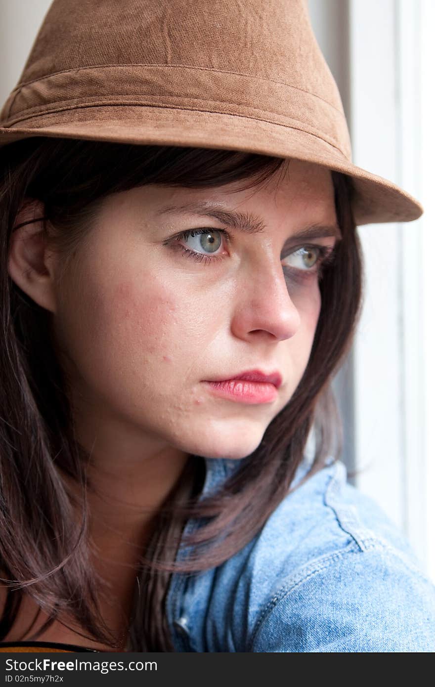 Close up of young stylish woman staring thoughtfully. Close up of young stylish woman staring thoughtfully