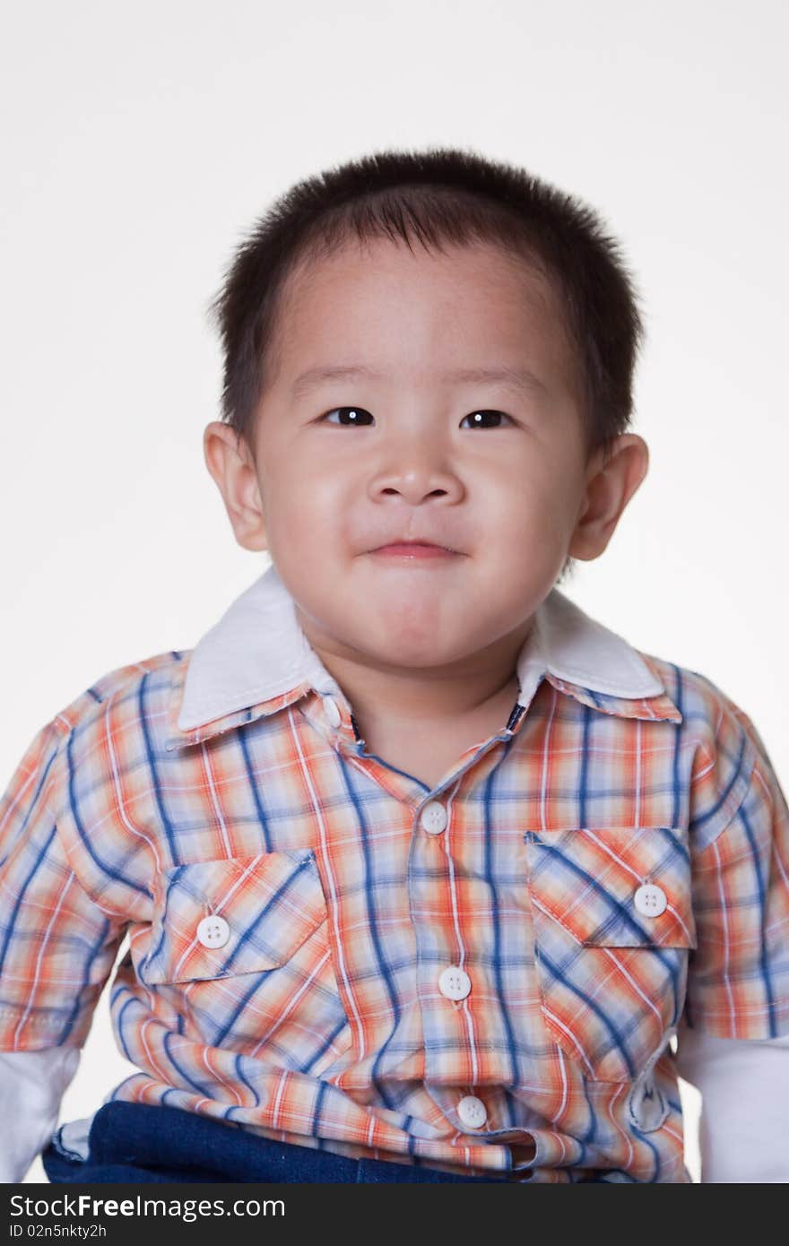 2 year old Asian boy in plaid shirt on white background