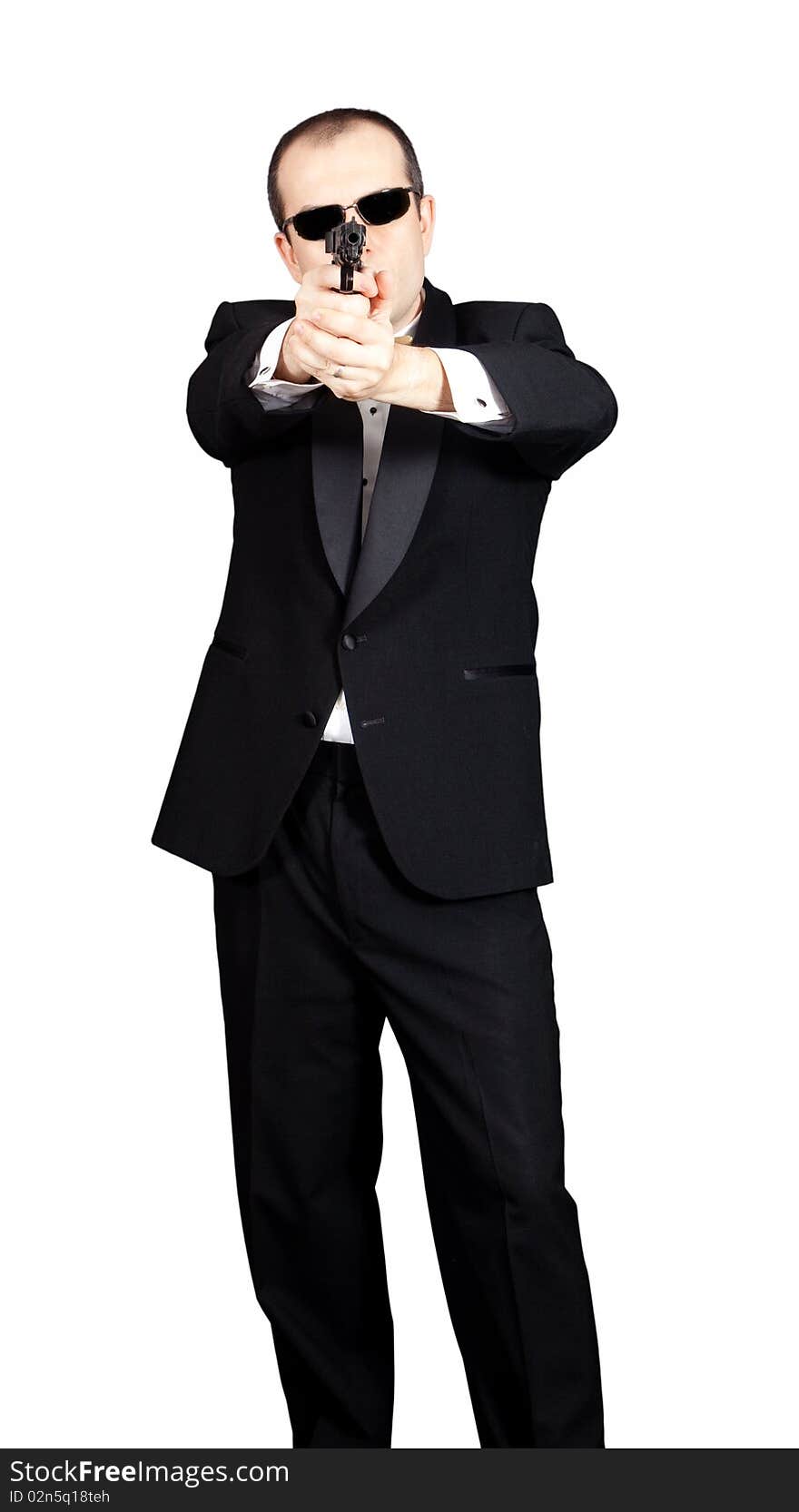 Man in tuxedo with a gun aiming at viewer. Man in tuxedo with a gun aiming at viewer