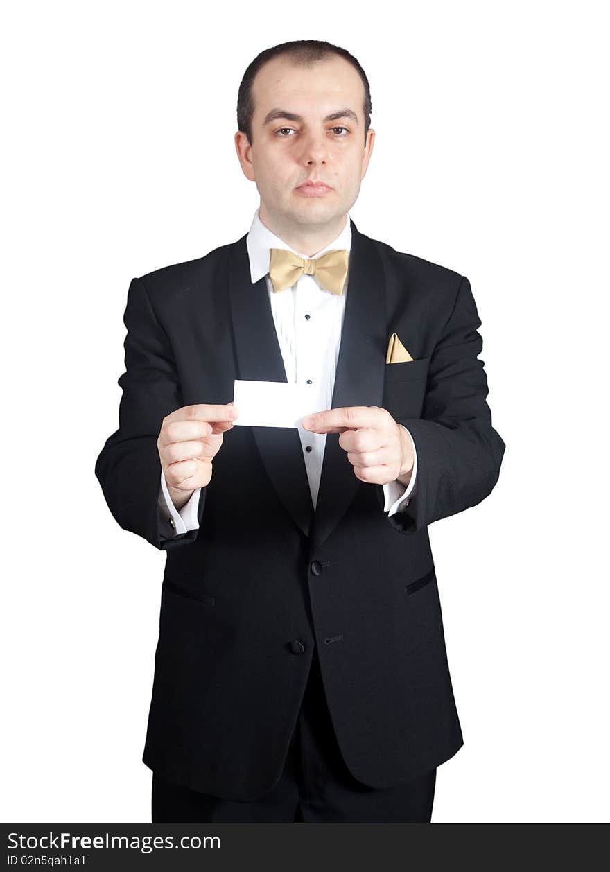 Man in tuxedo holding blank buisness card with both hands.