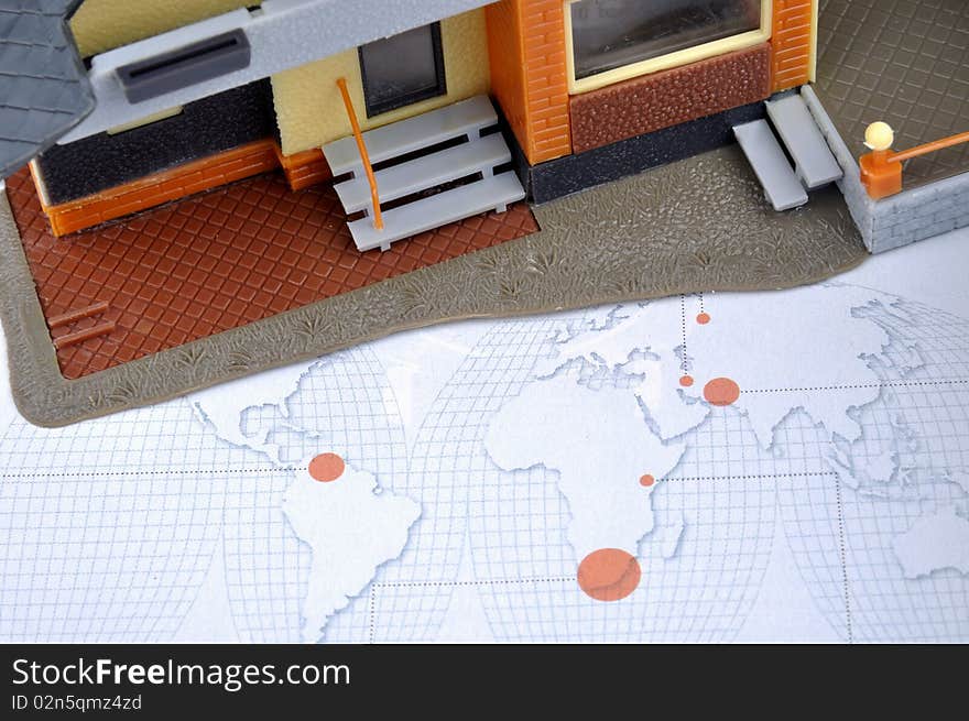 House model and world map, means world wide real estate market, industry and economy situation.