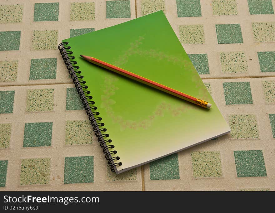 Note book and pencil on the table