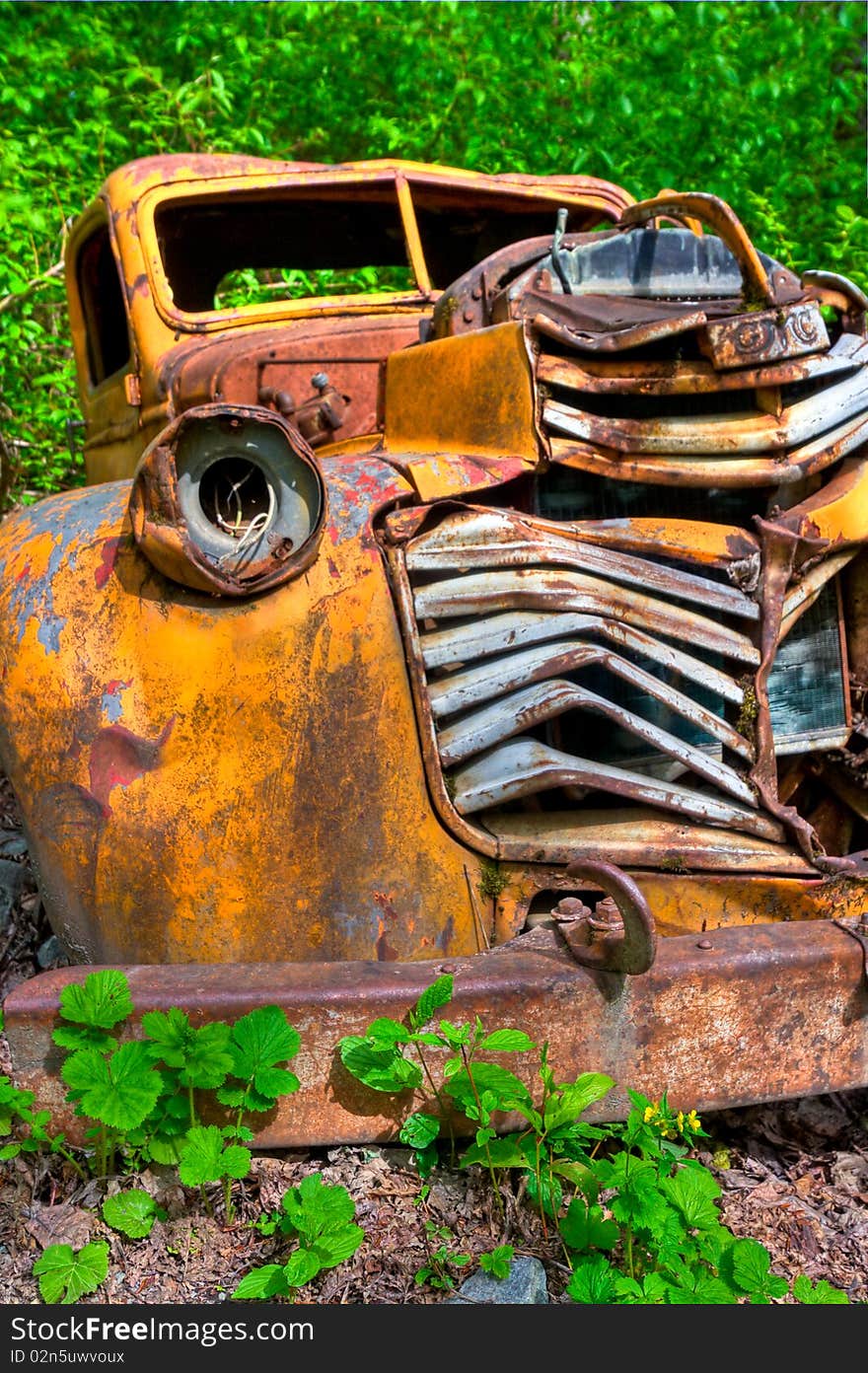 Old vintage vehicle left behind to rust and be vandalized. Old vintage vehicle left behind to rust and be vandalized