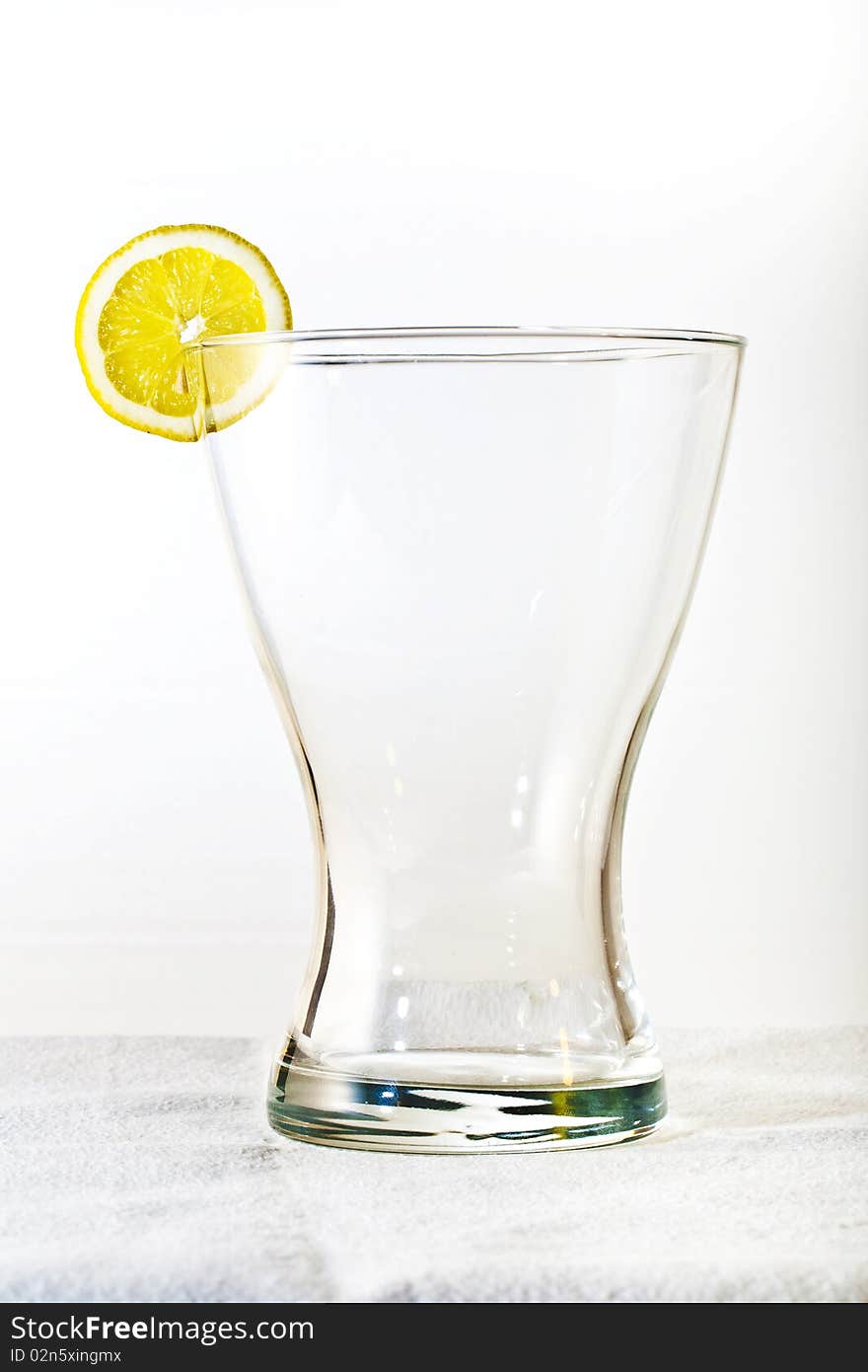 Slice of lemon at the top of the glass. Slice of lemon at the top of the glass