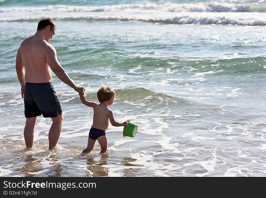 Father and son playing at sea