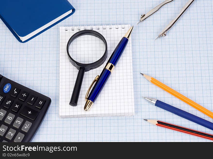 Book, calculator and pens at paper. Book, calculator and pens at paper