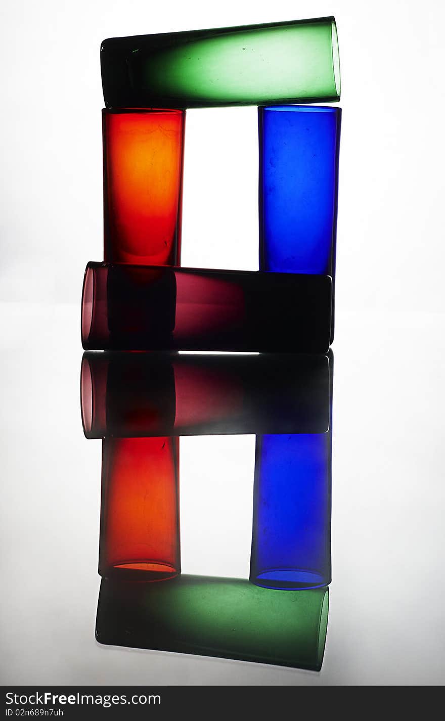 Colorful glasses on reflected table