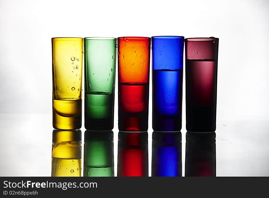 Colorful glasses on reflected table