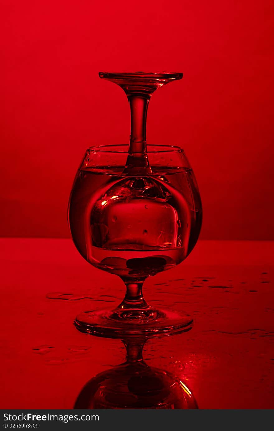 Glass in glass on red background