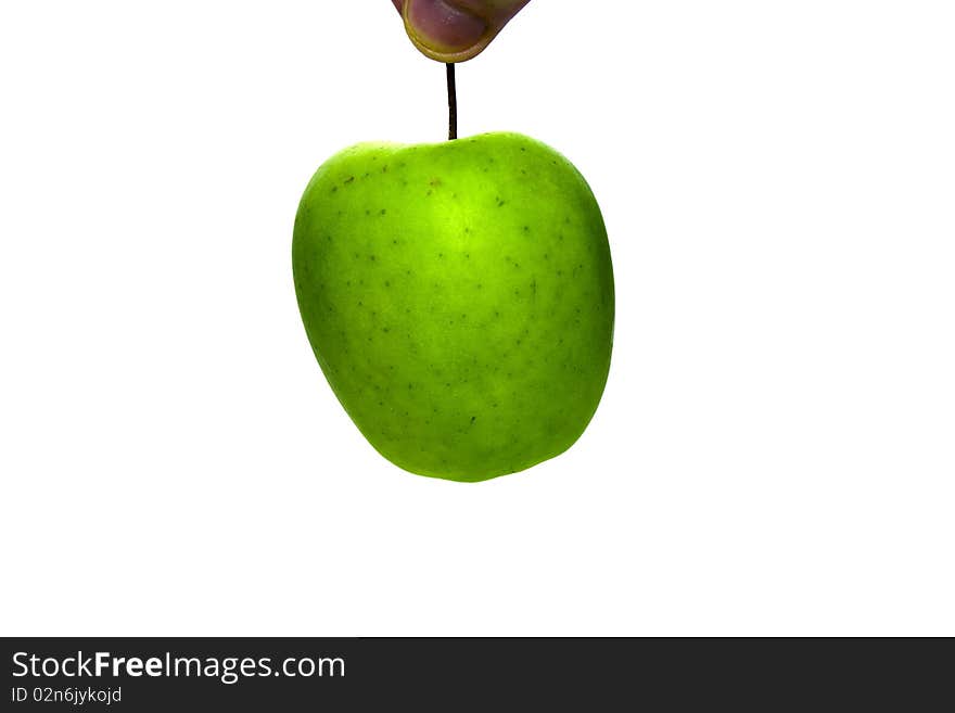 Green apple, which hold for tail by fingers. Green apple, which hold for tail by fingers