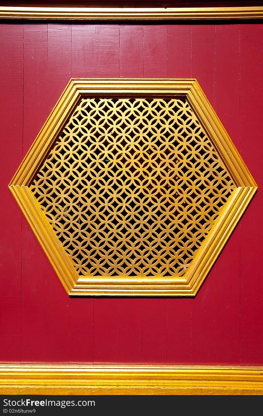 A Cinese golden window on the red wall. A Cinese golden window on the red wall