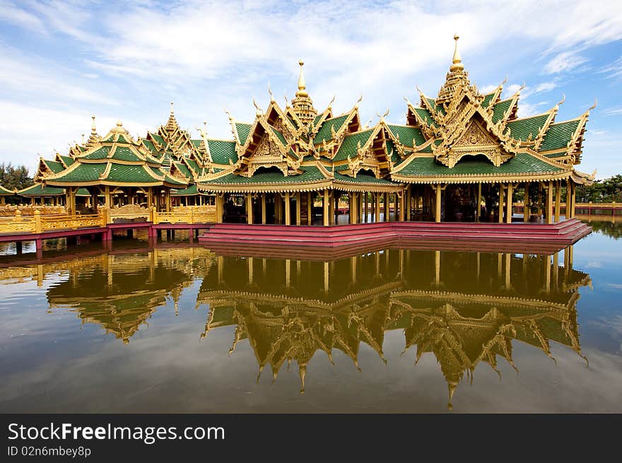 A green pavilion decorated by gold oriental texture on the lake. A green pavilion decorated by gold oriental texture on the lake