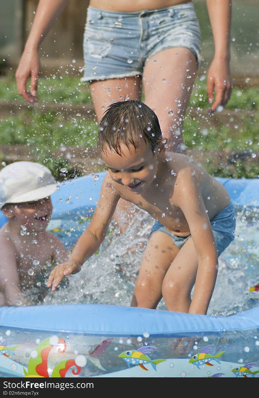 Boys frolic in rubber pool. Boys frolic in rubber pool