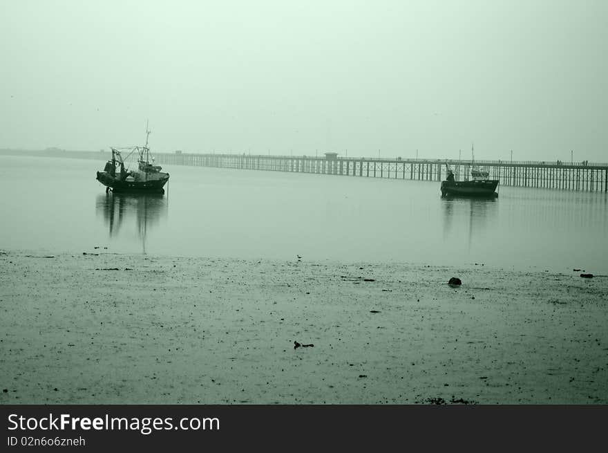 Boats In Norhern Sea In Misty Day