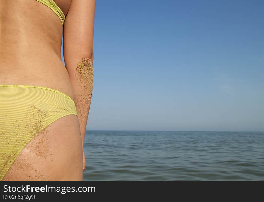 Woman body inf ront calm and sunny, empty beach. Woman body inf ront calm and sunny, empty beach.