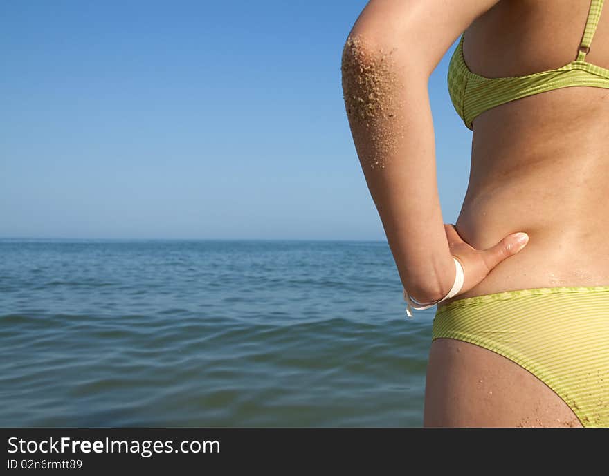 Woman body in front calm and sunny, empty beach. Woman body in front calm and sunny, empty beach.