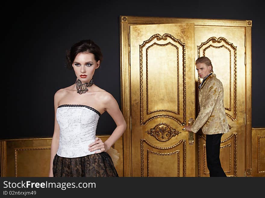 The beautiful girl and the young man in a gold interior. The beautiful girl and the young man in a gold interior