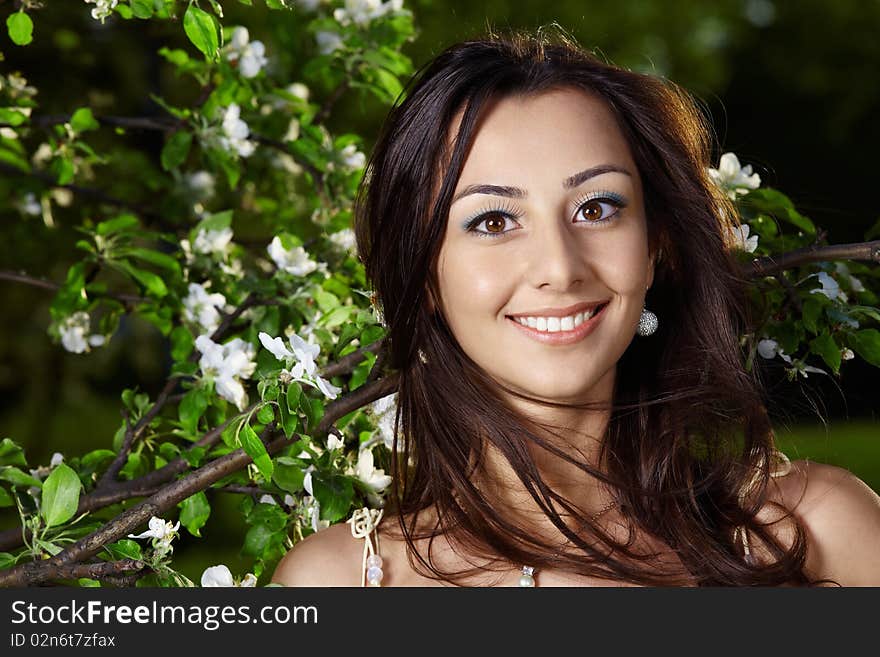 The young attractive girl in blossoming trees. The young attractive girl in blossoming trees