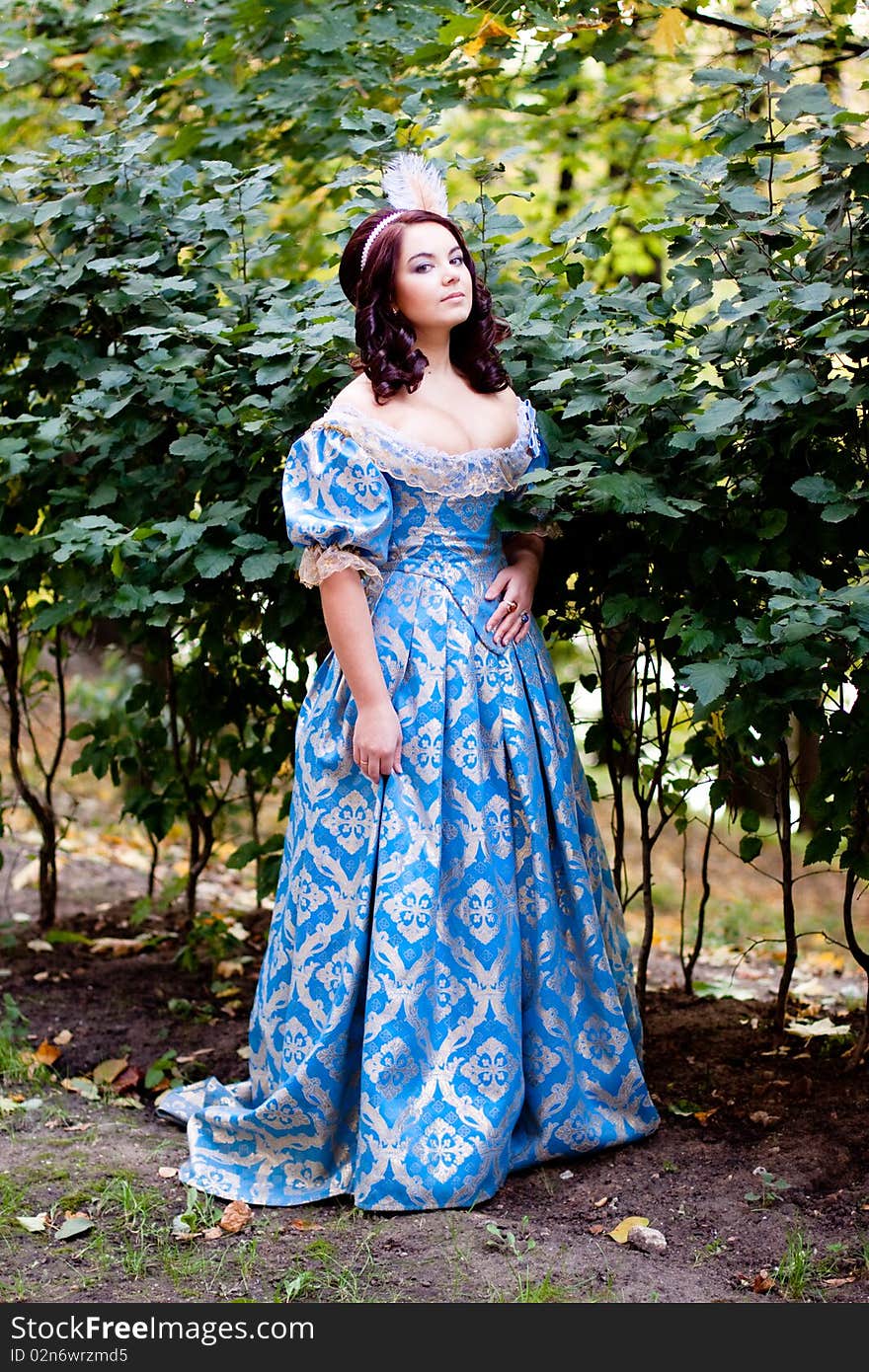 A portrait of lady in a blue baroque dress. A portrait of lady in a blue baroque dress