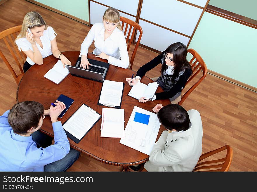 Group of business people interacting together at the office. Group of business people interacting together at the office.