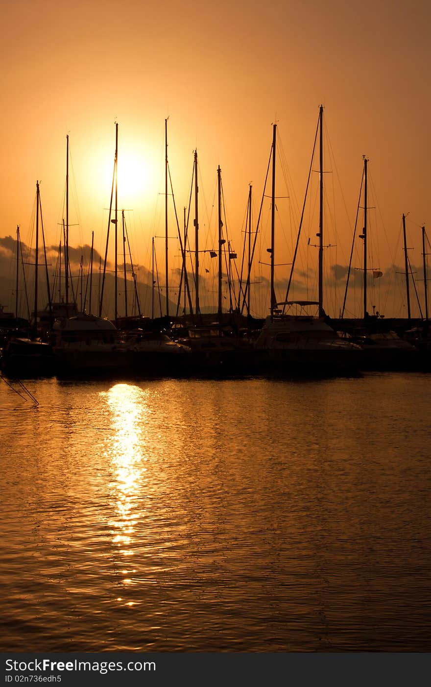 Hot sunset over marina with boats. Hot sunset over marina with boats