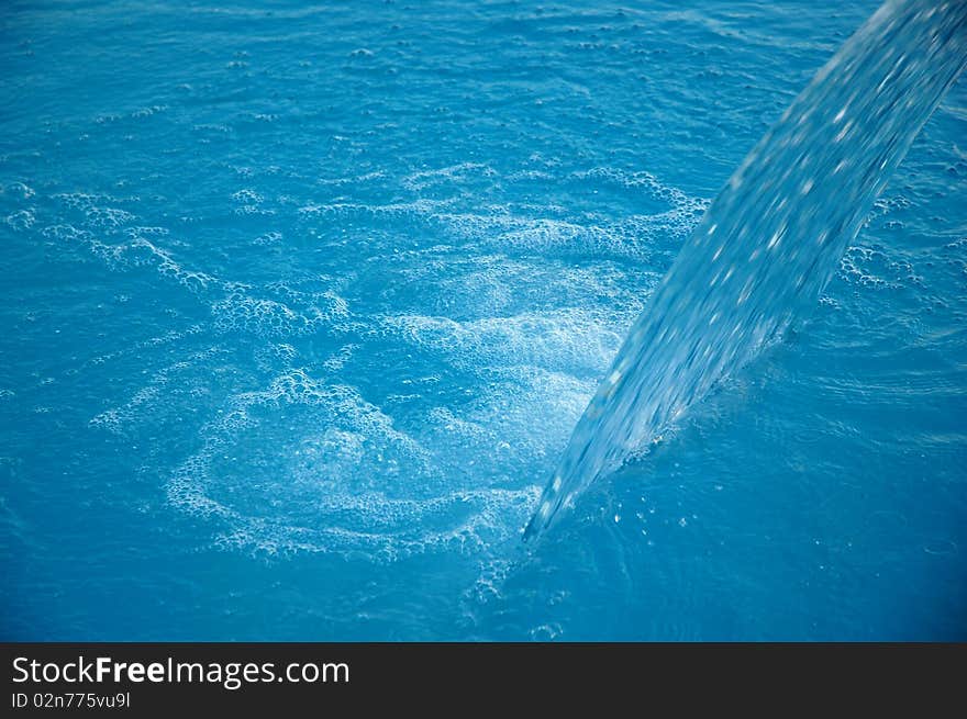 Dark blue water in pool with bubbles