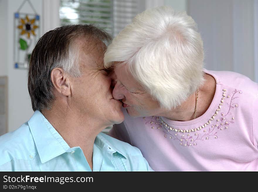 Senior romantic couple shares some intimate moments at their home. Senior romantic couple shares some intimate moments at their home.