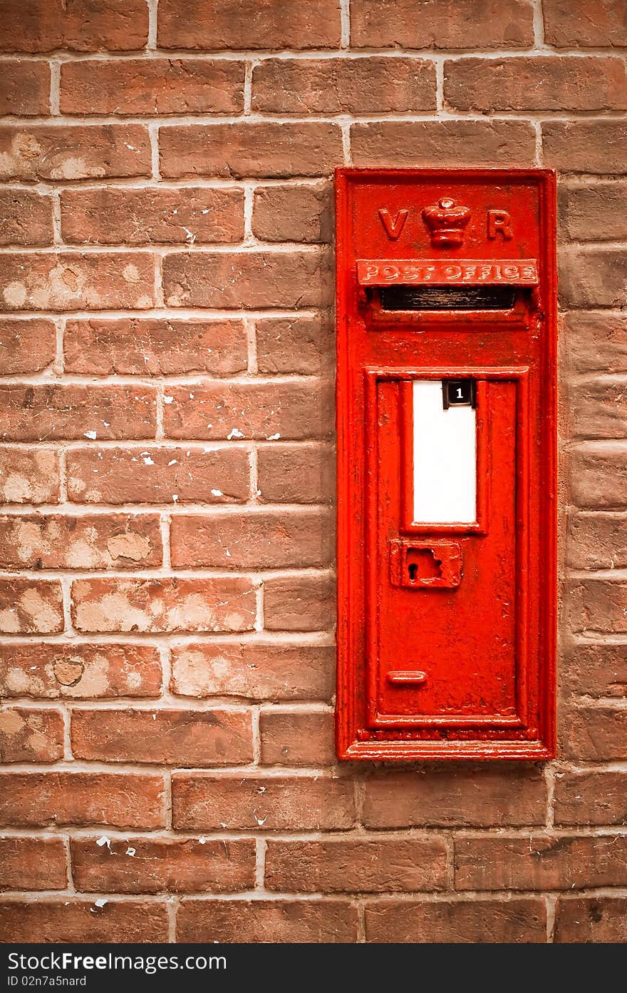 Victorian mail box abstract against a brick wall with blank white space for copy. Victorian mail box abstract against a brick wall with blank white space for copy